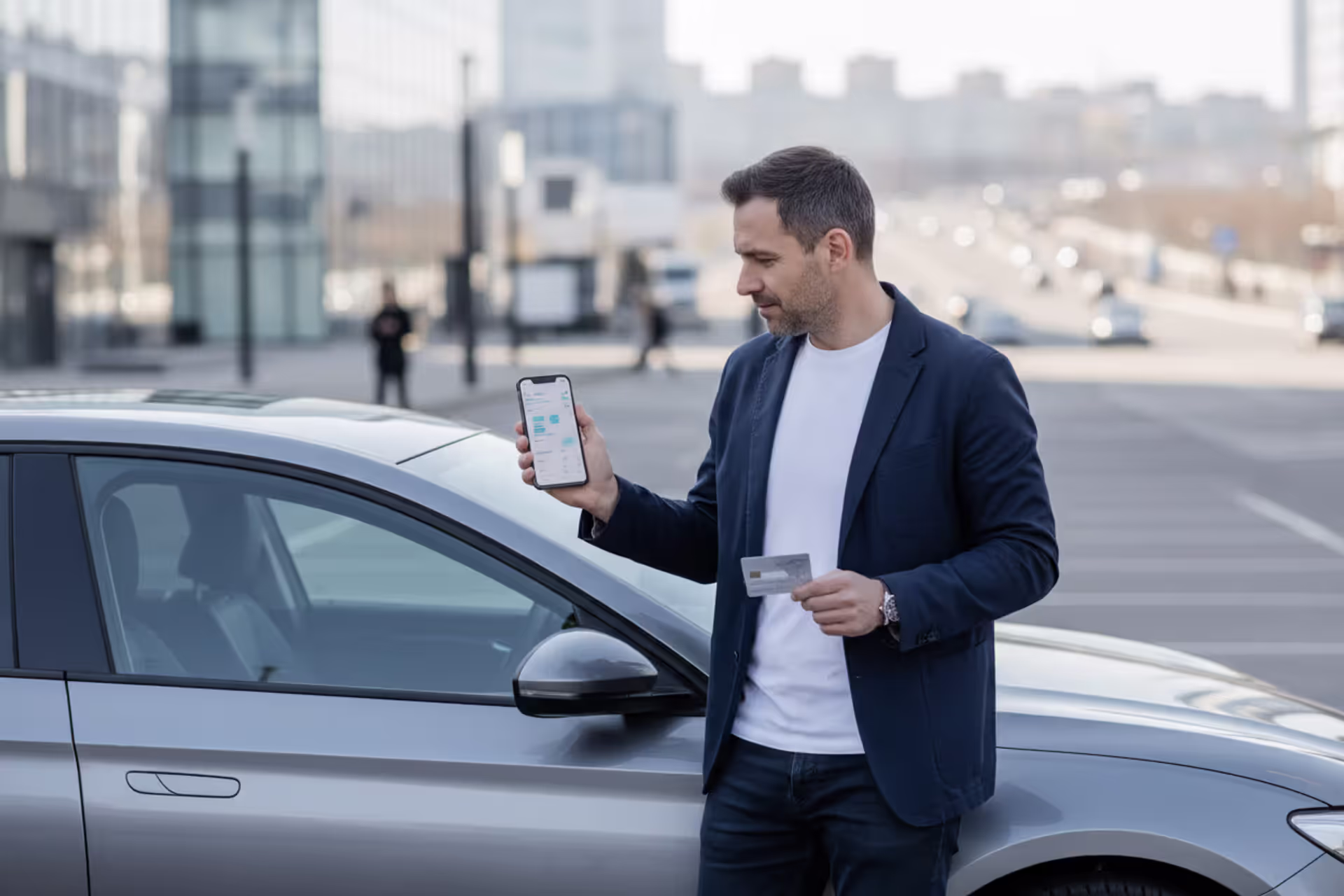 Person checking car loan payments on smartphone near parked car
